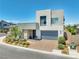 Contemporary two-story home with a two-car garage, stone accents and manicured landscaping at 4246 W Landberg Ave, Las Vegas, NV 89141