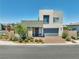Modern two-story home with a two-car garage, stone accents, and desert landscaping at 4246 W Landberg Ave, Las Vegas, NV 89141