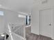 Bright, modern hallway with white walls, white banister, and gray carpet leads to the upstairs living area at 4246 W Landberg Ave, Las Vegas, NV 89141