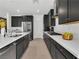 Modern kitchen with stainless steel appliances, dark cabinets, and a long island at 4246 W Landberg Ave, Las Vegas, NV 89141