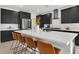 Stylish kitchen featuring dark cabinets, white counters, and stainless steel appliances at 4246 W Landberg Ave, Las Vegas, NV 89141
