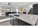 Open-concept kitchen with white countertops, dark cabinets, and a seamless flow to the living area at 4246 W Landberg Ave, Las Vegas, NV 89141