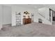 Spacious living area with modern decor, including shelving, and a staircase at 4246 W Landberg Ave, Las Vegas, NV 89141