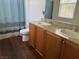 Clean bathroom offers a double sink vanity with granite counters at 4554 Townwall St, Las Vegas, NV 89115