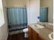 Bathroom featuring dual vanity sinks, framed mirrors, and a shower/tub at 4554 Townwall St, Las Vegas, NV 89115