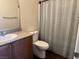 Bathroom features granite counters, light-colored walls, and neutral striped shower curtain at 4554 Townwall St, Las Vegas, NV 89115