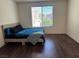 Bedroom with a window and hard wood flooring at 4554 Townwall St, Las Vegas, NV 89115