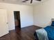 Bright bedroom featuring ceiling fan, hardwood floors, and adjoins the bathroom at 4554 Townwall St, Las Vegas, NV 89115