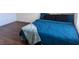 Modern bedroom features dark hardwood floors and a comfortable bed with blue comforter at 4554 Townwall St, Las Vegas, NV 89115