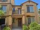 Two-story home with a balcony and a covered front porch, and manicured landscaping at 4554 Townwall St, Las Vegas, NV 89115