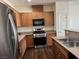 Well-lit kitchen features stainless steel appliances and wood cabinets at 4554 Townwall St, Las Vegas, NV 89115