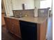 A kitchen island with a granite countertop and stainless steel sink at 4554 Townwall St, Las Vegas, NV 89115