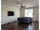Open living room with hardwood floors, a grey sofa and a mounted tv at 4554 Townwall St, Las Vegas, NV 89115