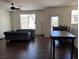 Spacious living room with hardwood flooring, sofa, and a dining table at 4554 Townwall St, Las Vegas, NV 89115