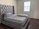 Neutral-toned main bedroom with dark wood floors and natural light at 4554 Townwall St, Las Vegas, NV 89115