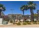 Community pool surrounded by palm trees and lush landscaping at 4554 Townwall St, Las Vegas, NV 89115
