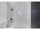 This renovated bathroom features marble walls and a new bathtub at 4571 Sirius Ave, Las Vegas, NV 89102