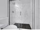 This renovated shower features marble walls, a black-tiled floor, and modern fixtures at 4571 Sirius Ave, Las Vegas, NV 89102