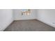 This bedroom features neutral walls, gray carpet, and a bright window at 4571 Sirius Ave, Las Vegas, NV 89102
