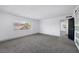 This bedroom features neutral walls, gray carpet, and a large window at 4571 Sirius Ave, Las Vegas, NV 89102