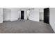 This bedroom features neutral walls, gray carpet, and multiple closet/bathroom entrances at 4571 Sirius Ave, Las Vegas, NV 89102