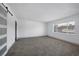 This bedroom features neutral walls, gray carpet, and a sliding barn door at 4571 Sirius Ave, Las Vegas, NV 89102