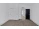 This bedroom features neutral walls, gray carpet, and a bright window at 4571 Sirius Ave, Las Vegas, NV 89102