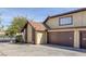 Exterior view of the townhome featuring an attached 2-car garage and well-kept landscape at 4571 Sirius Ave, Las Vegas, NV 89102