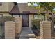 Charming townhome featuring a well-kept front yard with mature landscaping and a welcoming brown front door at 4571 Sirius Ave, Las Vegas, NV 89102