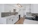 A modern kitchen featuring white cabinets, stainless steel appliances, and stylish backsplash at 4571 Sirius Ave, Las Vegas, NV 89102
