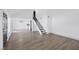 Bright, open living room with hardwood floors, stairs, and contemporary lighting, offering a welcoming space at 4571 Sirius Ave, Las Vegas, NV 89102