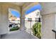 Charming balcony with stucco arches and black railings overlooking lush greenery and community buildings at 4860 Nara Vista Way # 204, Las Vegas, NV 89103