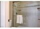 The bathroom features glass shower doors and neutral tile surround at 4860 Nara Vista Way # 204, Las Vegas, NV 89103