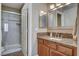 Bathroom with granite countertops, under sink cabinets, and glass-doored shower at 4860 Nara Vista Way # 204, Las Vegas, NV 89103