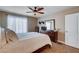 Bright bedroom featuring a ceiling fan, dresser, and large window with sheer curtains at 4860 Nara Vista Way # 204, Las Vegas, NV 89103