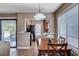 Cozy dining room with access to balcony and modern lighting fixture at 4860 Nara Vista Way # 204, Las Vegas, NV 89103