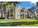 Two-story building with balconies, well-kept lawn, and mature trees enhancing the curb appeal at 4860 Nara Vista Way # 204, Las Vegas, NV 89103