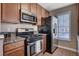 Well-lit kitchen with stainless steel appliances, granite countertops, and wood cabinets at 4860 Nara Vista Way # 204, Las Vegas, NV 89103