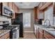Galley style kitchen showcasing stainless steel appliances and granite countertops at 4860 Nara Vista Way # 204, Las Vegas, NV 89103