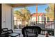 Private balcony with a black iron railing and outdoor patio seating with neighborhood view at 4860 Nara Vista Way # 204, Las Vegas, NV 89103