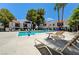 Community pool with lounge chairs and palm trees offering a tranquil resort-style experience at 4860 Nara Vista Way # 204, Las Vegas, NV 89103