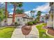 Landscaped walkway with mature trees and plantings leading to the buildings with a serene ambiance at 4860 Nara Vista Way # 204, Las Vegas, NV 89103