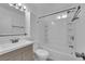 Clean bathroom featuring a sink, vanity, toilet, and bathtub with white tile surround at 5029 Spencer St # D, Las Vegas, NV 89119