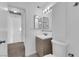 A clean and bright bathroom featuring a modern vanity, toilet, and double mirrors at 5029 Spencer St # D, Las Vegas, NV 89119