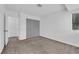 Neutral bedroom with carpet, a window and a closet with custom patterned door at 5029 Spencer St # D, Las Vegas, NV 89119