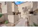 Charming condo exterior with textured walls, gated entry, and tidy landscaping at 5029 Spencer St # D, Las Vegas, NV 89119