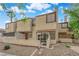 Inviting two-story townhome with a desert landscape, private front patio entrance, and secure gate at 5029 Spencer St # D, Las Vegas, NV 89119