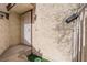 Front entrance with security gate and textured exterior walls, featuring an entry keypad at 5029 Spencer St # D, Las Vegas, NV 89119