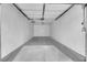 Spacious, empty garage with smooth concrete floors and white walls ready for use at 5029 Spencer St # D, Las Vegas, NV 89119
