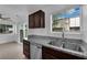 Kitchen area with stainless steel sink, granite counters, dark cabinets and neutral paint at 5029 Spencer St # D, Las Vegas, NV 89119